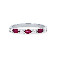 a white gold ring with three oval ruby stones on the side and four round diamonds in the middle