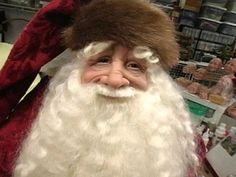 a close up of a santa clause wearing a hat