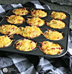 a muffin tin filled with mini quiche cups