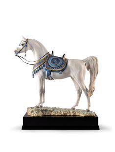 a figurine of a white horse with blue accents