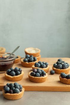 small blueberry pies on a wooden cutting board