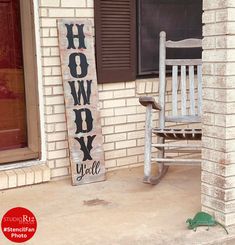 a rocking chair sitting on the porch next to a sign