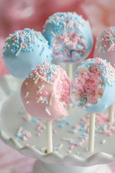 Pastel-colored cake pops with pink and blue sprinkles on a white stand. Baby Gender Reveal Ideas, Gender Reveal Activities, Gender Reveal Cake Pops, Gender Reveal Party Food