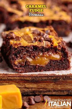 chocolate caramel fudge brownies are stacked on top of each other, with one piece cut out