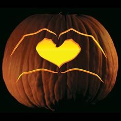 a carved pumpkin with the shape of a bat on it's face and hands