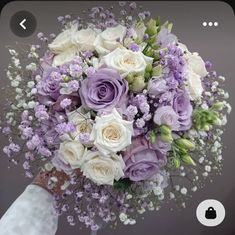 a bridal bouquet with purple and white flowers