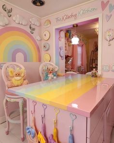 a child's room with a desk and chairs