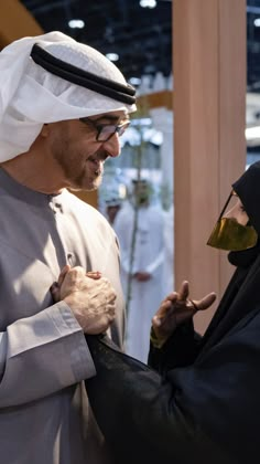 two men dressed in traditional clothing are talking