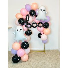 a balloon arch with balloons and ghost decorations