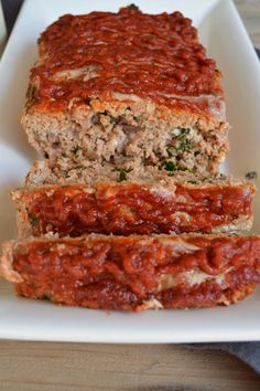 meatloaf with marinara sauce on a white plate