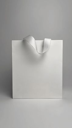 an empty white box with a ribbon on the top and bottom, against a gray background