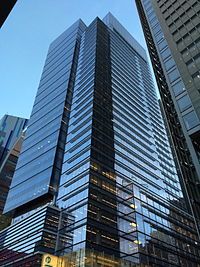 two tall skyscrapers in the city at dusk