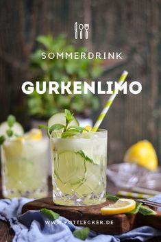 two glasses filled with lemonade and garnish on top of a wooden table