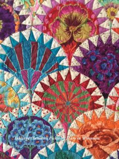 an image of a colorful quilt with many different colors and designs on the front side