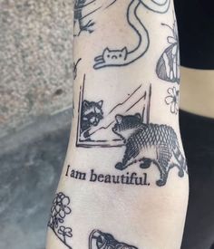 a person's arm with tattoos on it that say i am beautiful and cats