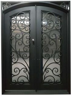 a black double door with intricate ironwork and glass panels on the front entrance to a home