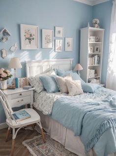 a bedroom with blue walls and white furniture in the corner is decorated with pictures on the wall