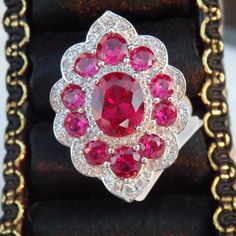 This Ring Is A Size 7. With A 2.43ct Oval And 2.90ctw Round Lab Created Ruby With .68ctw Round Lab Created White Sapphire, Rhodium Over Sterling Silver Ring. Measures Approximately .87"L X 1.21"W. Not Sizeable. With Finished Under Gallery. Brilliant Cut Ruby Gemstones For Fine Jewelry, Brilliant Cut Ruby Gemstones Fine Jewelry, Oval Ruby Ring With Diamond Cut In Platinum, Platinum Ruby Ring With Diamond Cut, Fine Jewelry Ruby Ring With Accent Stones In Platinum, Platinum Ruby Ring With Accent Stones, White Gold Ruby Cluster Ring With Brilliant Cut, Ruby Ring With Accent Stones In Platinum, White Gold Cluster Ruby Ring