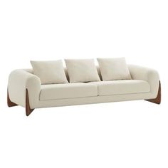 a white couch with four pillows on it