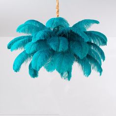 a blue feather chandelier hanging from a ceiling