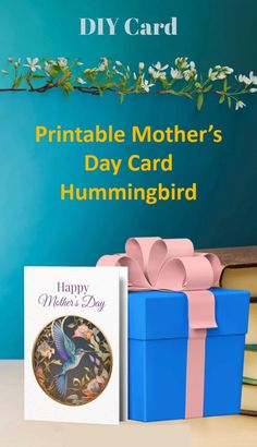 a blue gift box with a pink bow next to it and the words printable mother's day card hummingbird