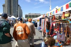 people are walking through an outdoor market area