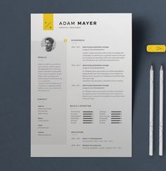 a clean and modern resume is displayed on a table with two pencils next to it