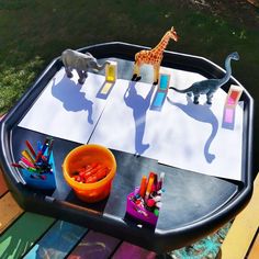 an outdoor play table with toys on it