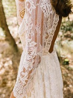 a woman wearing a white dress in the woods