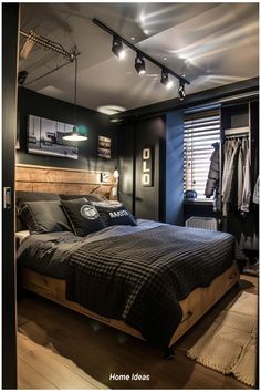 a bed room with a neatly made bed and some lights on the wall above it