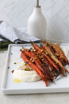 carrots and other vegetables on a white plate