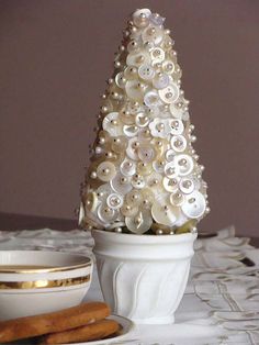 a white christmas tree made out of buttons