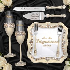 a table setting with champagne glasses and silverware