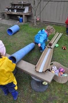 two children playing with toys in the yard