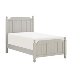 a white bed with wooden headboard and foot board on top of the bed frame