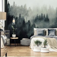 a bedroom with a forest mural on the wall