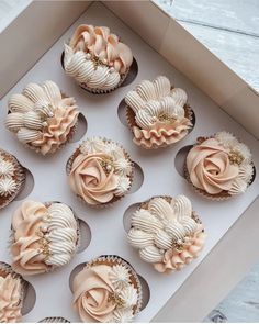 twelve cupcakes in a box decorated with flowers