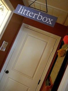 there is a sign that says litter box above the door