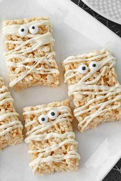 rice krispy treats with eyes and googly eyes are on a white platter