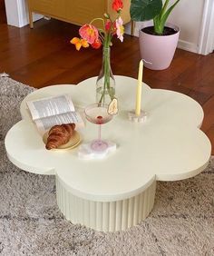 a coffee table with flowers and candles on it