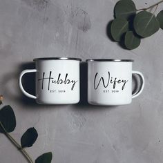 two white coffee mugs with the words hubby wife and hubby wife on them