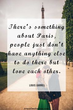 two people standing in front of the eiffel tower with a quote about love