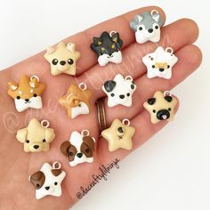 a hand holding a bunch of small animal charms