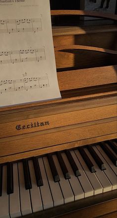 an old piano with sheet music on it