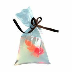 a bag filled with goldfish on top of a white background