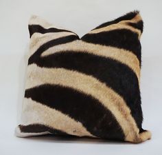 a zebra print pillow is shown on a white background with black and tan stripes,