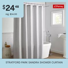 a white bath tub sitting next to a shower curtain