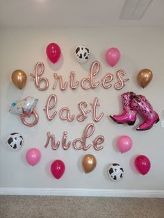 the bride's east ride sign is surrounded by balloons and cowboy boots, along with other decorations