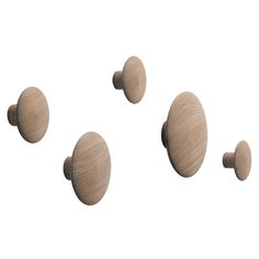 three wooden knobs are shown on a white background