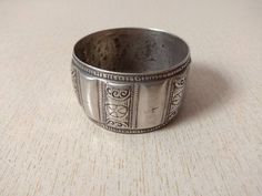 A superb old berber silver bracelet from Morocco. Made of high grade silver, the surface of the bangle has been finely hand-etched with a design combining lines, and the surface as well as interior have both obtained a very rich patina from wear and usage. Excellent patina, mid 20th century. Inner diameter : 6,3 cm (2,48 inches) Width : 3,8 cm (1,5 inches) Weight : 119 g Traditional Wide Band Engraved Jewelry, Silver Engraved Wide Band Bangle, Traditional Engraved Wide Band Jewelry, Traditional Silver Wide Band Jewelry, Traditional Ceremonial Stamped Bangle, Silver Stamped Ceremonial Bangle, Traditional Stamped Ceremonial Bangle, Ceremonial Silver Stamped Bangle, Traditional Stamped Sterling Silver Bangle